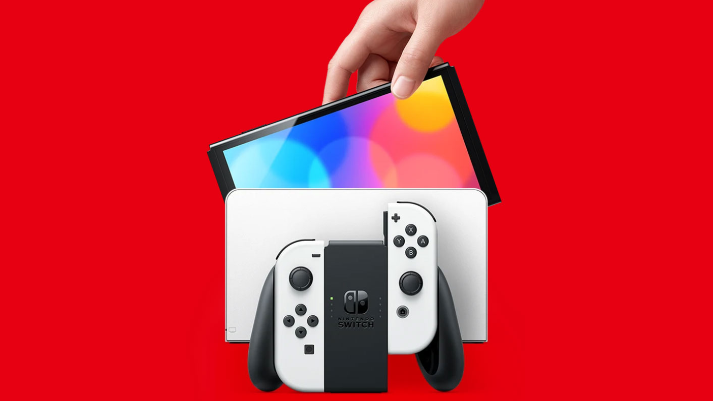 Hand lifting Nintendo Switch OLED out of dock with Joy Con controllers in front
