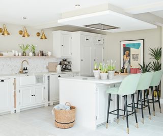 white kitchen with island and green stools with black legs