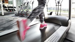 Close up of a runner's shoes on a treadmill