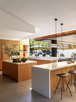 Modern kitchen with wooden island and large windows