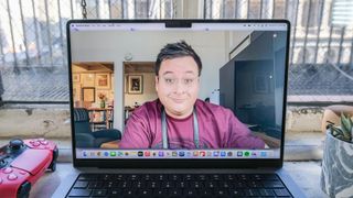 The MacBook Pro 2021 (14-inch) open to the author seen in a QuickTime video recording