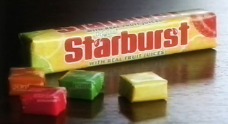 Ad showing Starburst packet and individual sweets on table