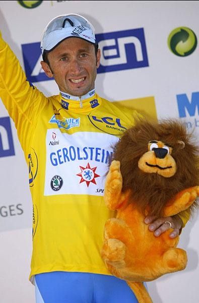 Looking good in yellow Davide Rebellin even cracks a smile on the podium.