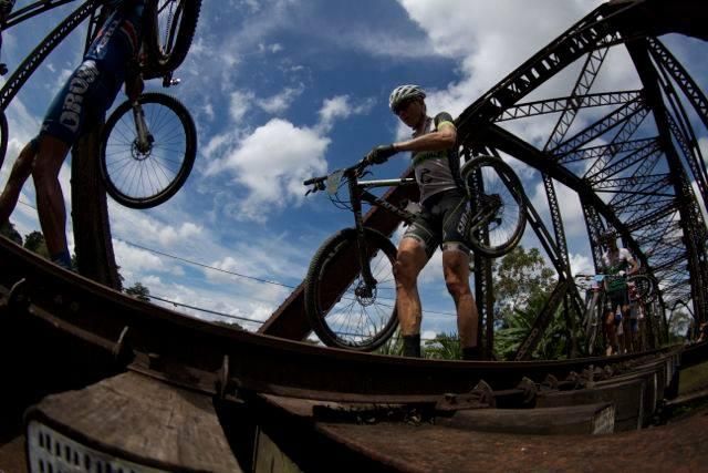 Alex Grant on a railroad bridge crossing