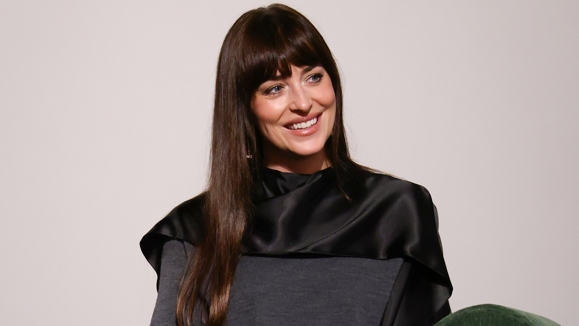 Dakota Johnson was spotted in NYC wearing a $11,000 Valentino coat, a Valentino Panthea Bag, and the triangle scarf trend