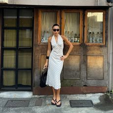 camelia wears a polka dot set and thong heels and there are two other photos of shoes on each side of the polka dot outfit