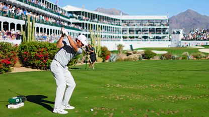 Scottie Scheffler tees off at the 16th at TPC Scottsdale