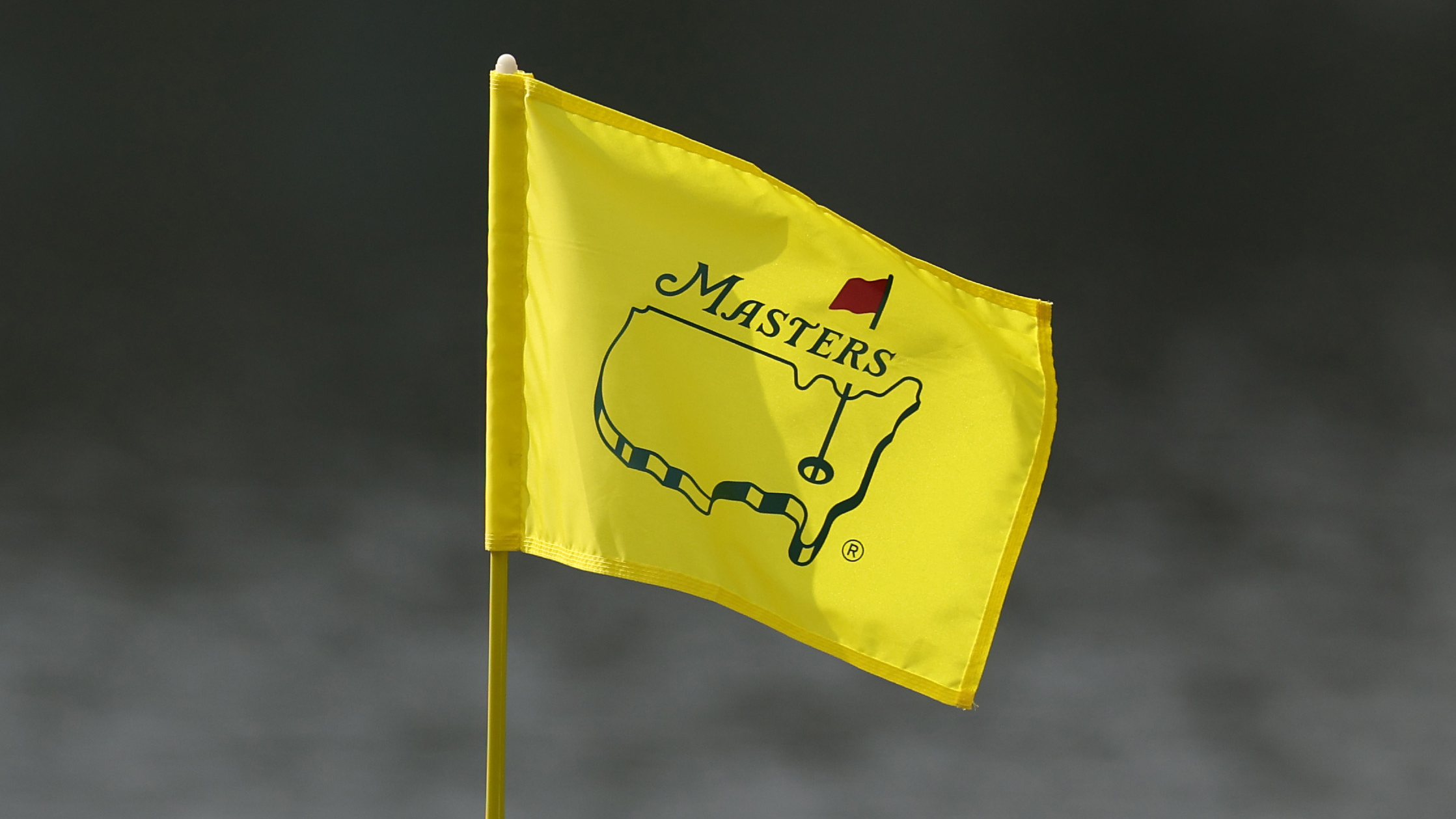 A yellow Masters flag blowing in the wind