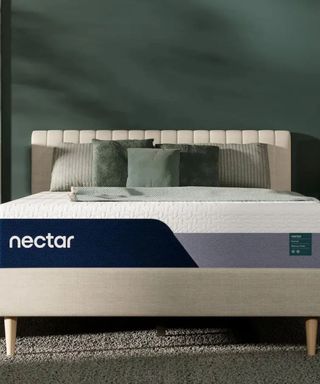 Nectar Premier Memory Foam Mattress on a bed against a green wall.