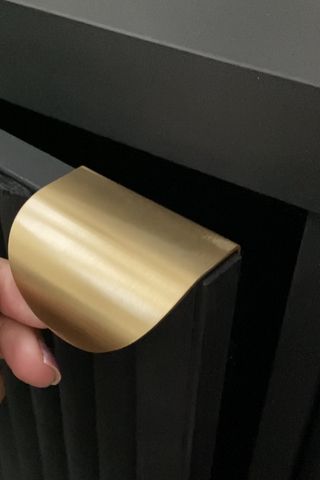 Gold handle attached to a black door