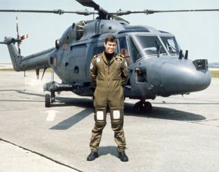 Prince Andrew standing in front of a helicopter