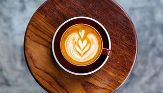 Cup of coffee standing on a round coffee table