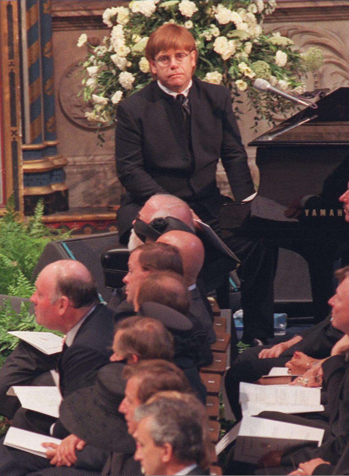 Elton John sitting at the piano at Princess Diana's funeral