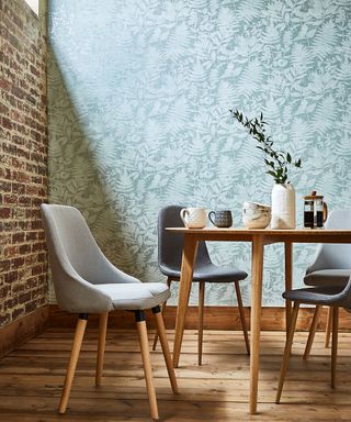 dining area with blue floral wallpaper and table