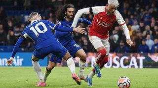 Chelsea pair Marc Cucurella and Mykhailo Mudryk challenge Arsenal's Ben White in the sides' Premier League clash at Stamford Bridge in October 2023.