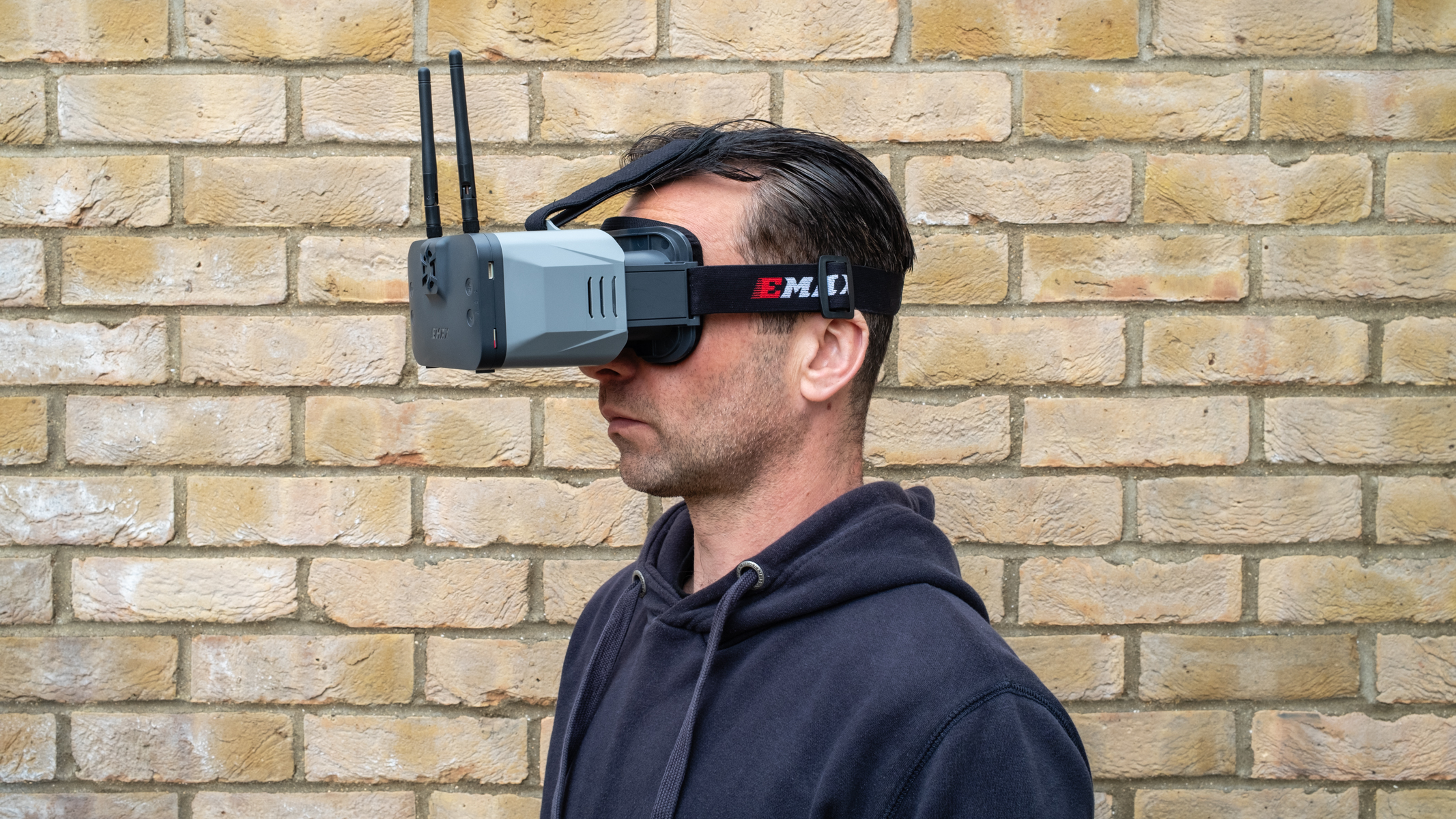 A man wearing Emax Transporter 2 HD FPV Goggles