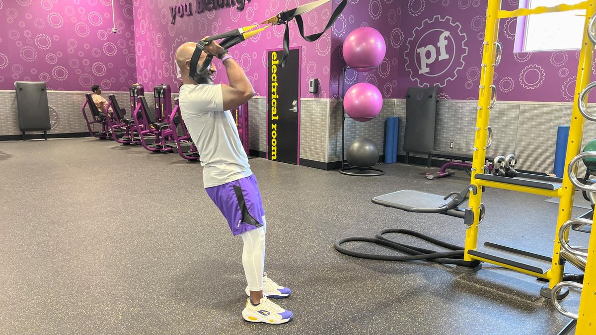 Teddy Savage performing a TRX biceps curl