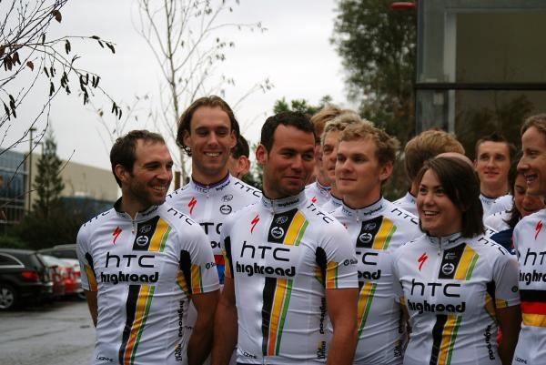 Mark Cavendish is pulled around to the front for the team photo.