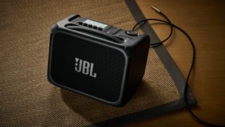 A JBL BandBox Trio guitar amp on a rug