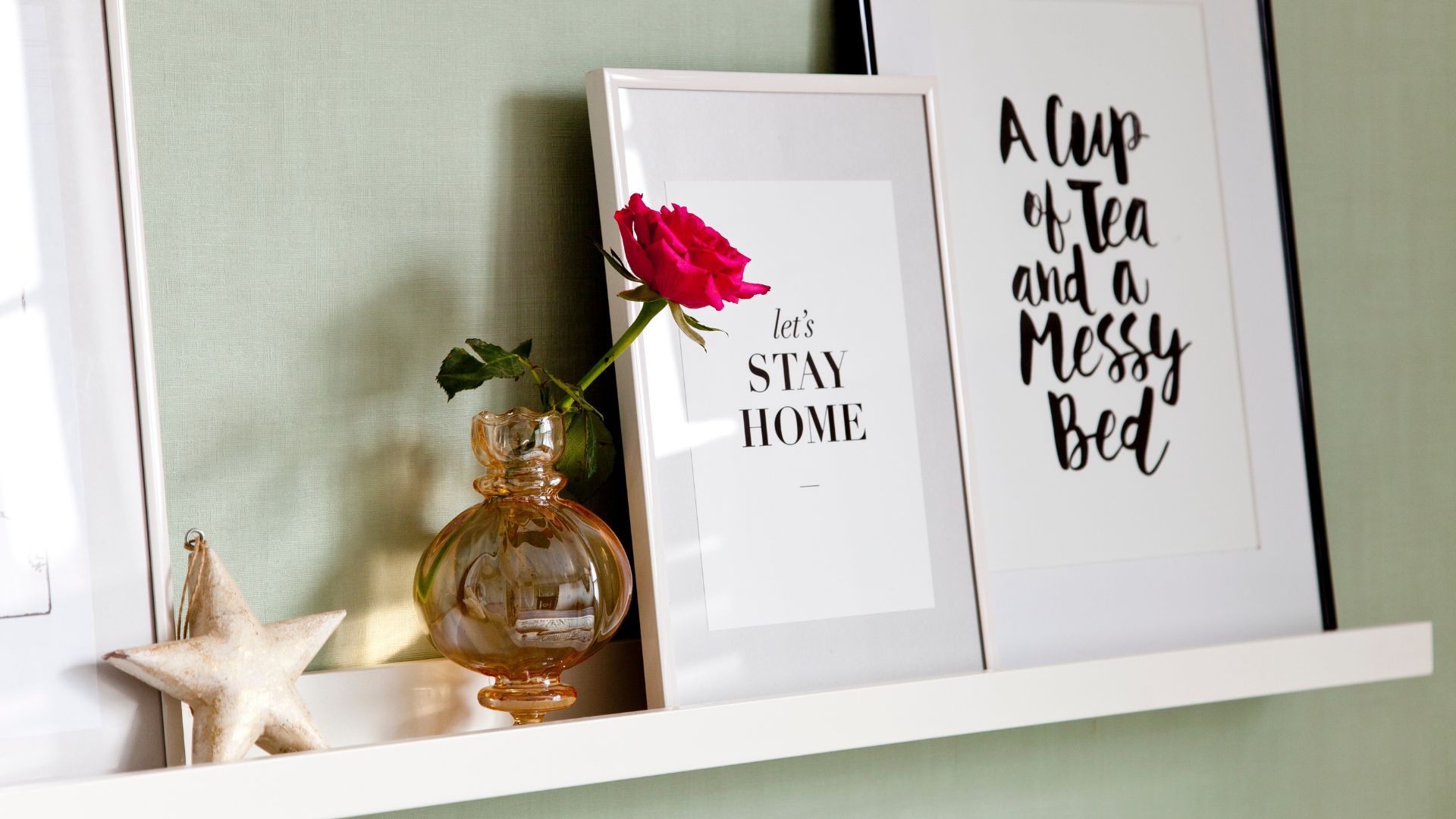 picture frames and decor on a white shelf