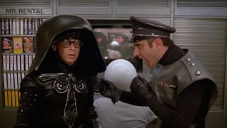 George Winer explains Instant Cassettes to a confused Rick Moranis in Spaceballs.