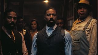 Michael B. Jordan as Smoke and as Stack in doorway in Sinners