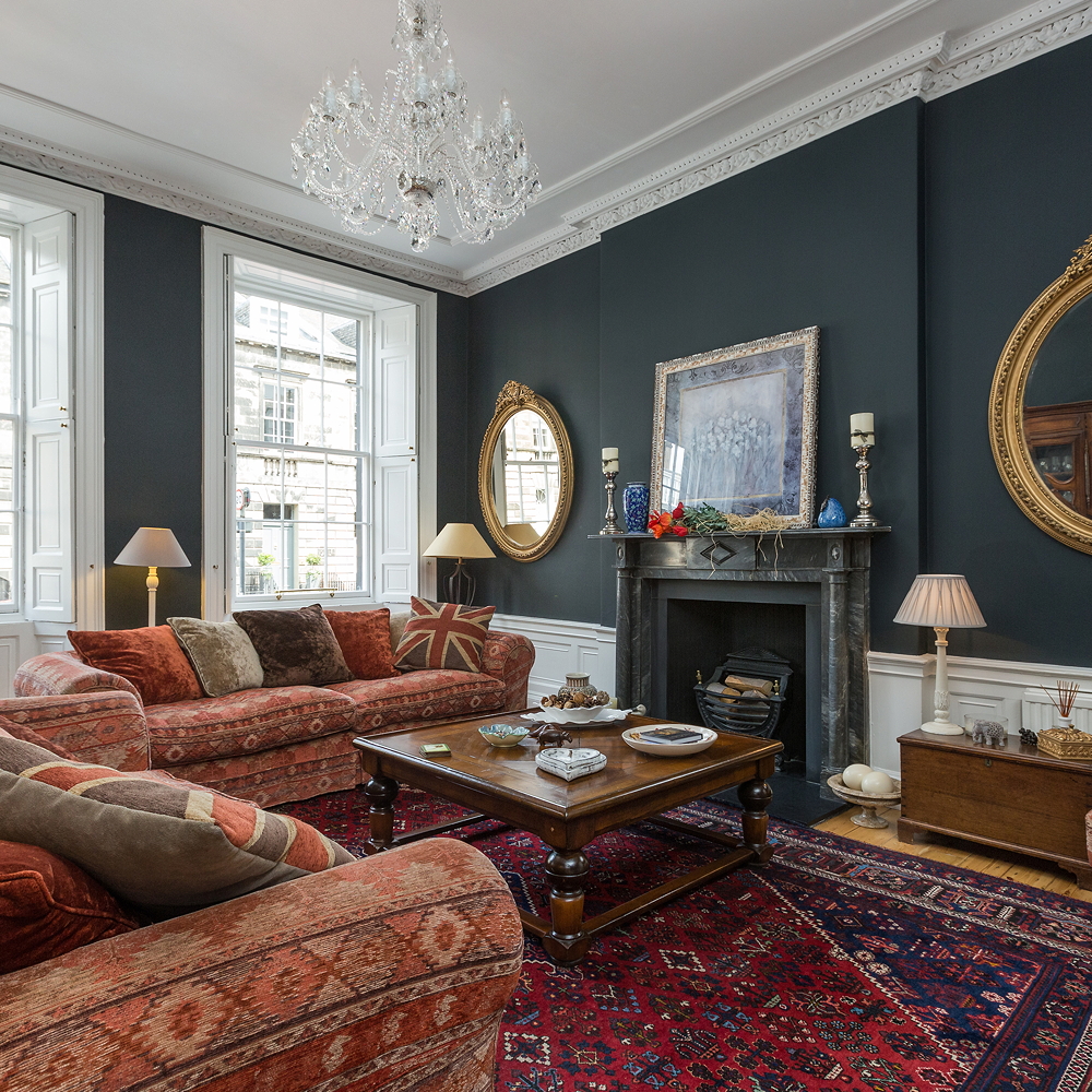living room with grey wall fireplace and sofa