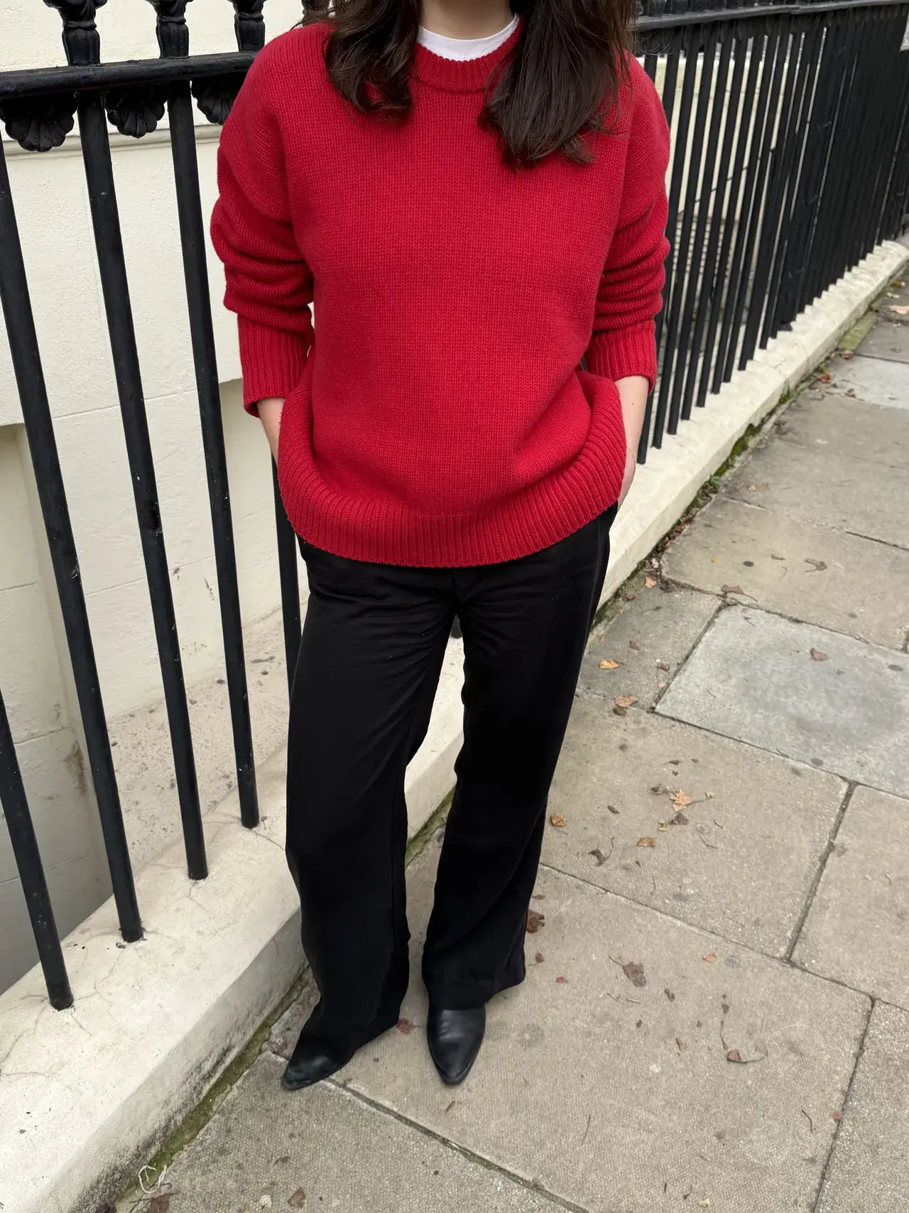 News writer, Natalie, wears a red jumper, black tailored trousers and boots