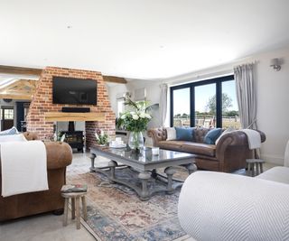 A rustic and cosy living room with log burner and brick chimney breast