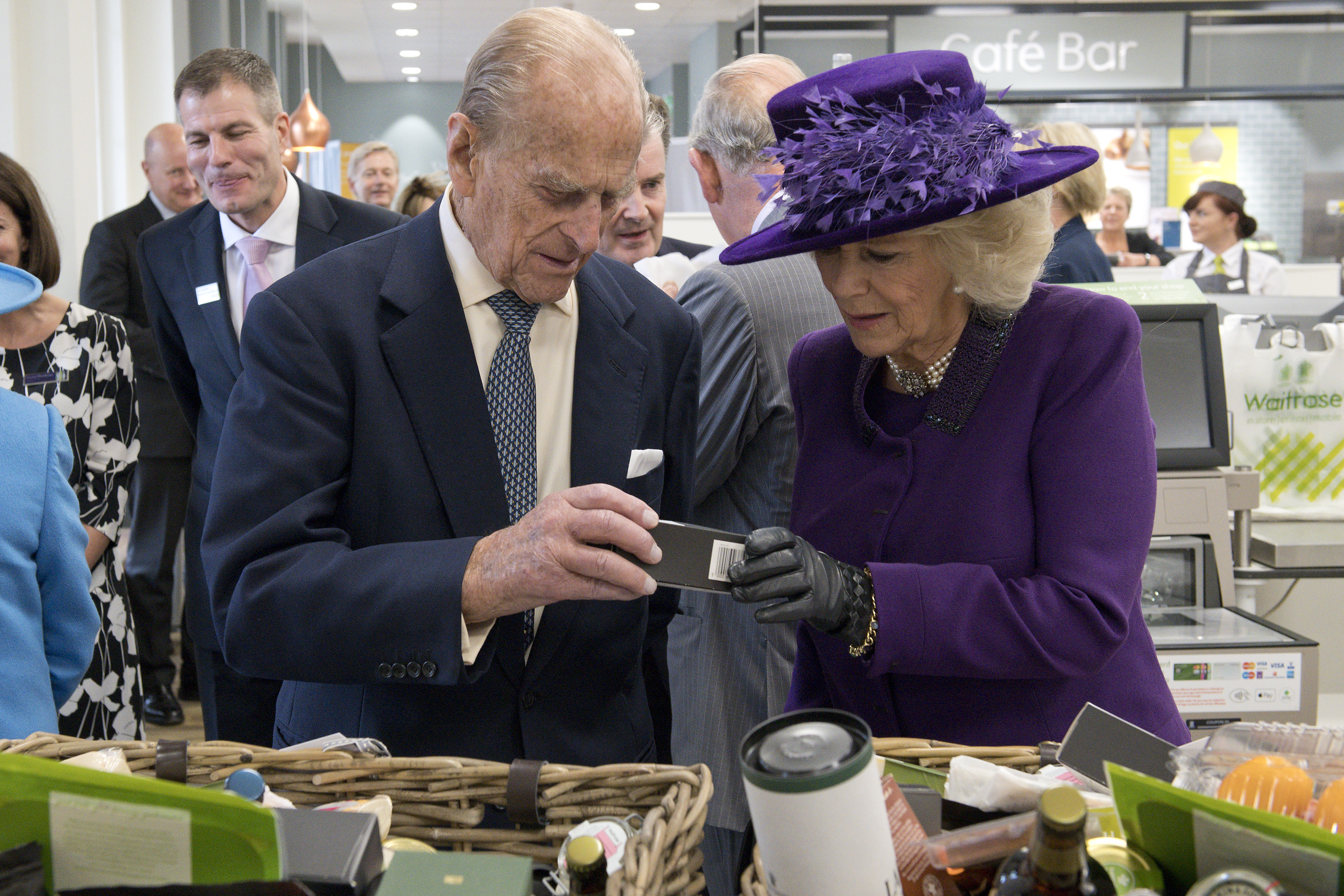 Prince Philip and Queen Camilla looking at boxes of food