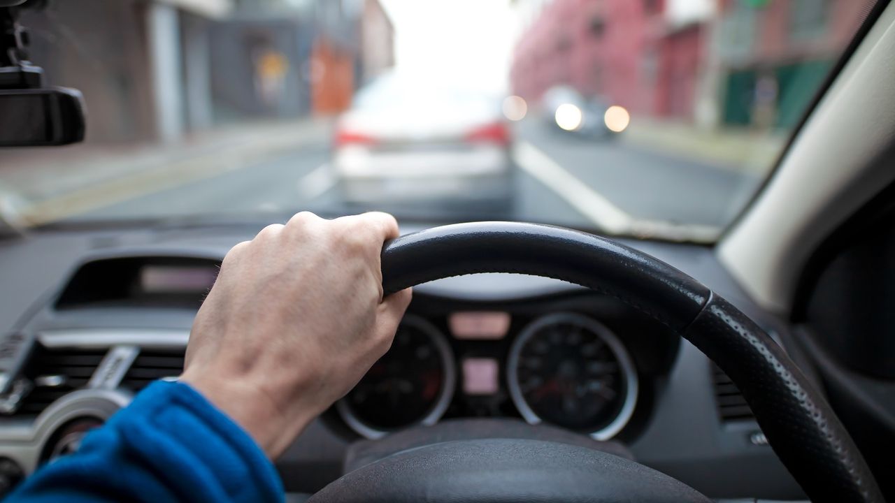 A driver at the wheel of a car