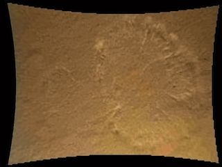 This image from Curiosity's Mars Descent Imager illustrates the roughly circular swirls of dust kicked up from the Martian surface by the rocket motor exhaust. At this point, Curiosity is about 70 feet (20 meters) above the surface. This dust cloud was generated when the Curiosity rover was being lowered to the surface while the sky crane hovered above. Curiosity landed on Mars on the night of Aug. 5, and this photo was released by NASA on Aug. 6, 2012.