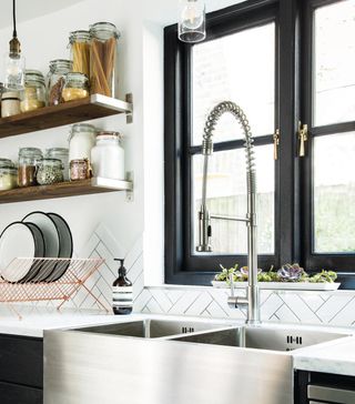 kitchen with sink tap and shelf with window and metro tiles