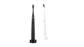 Aeno electric toothbrush in black and white colourways on wireless charging platform