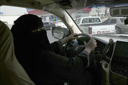 A Saudi woman drives her car.
