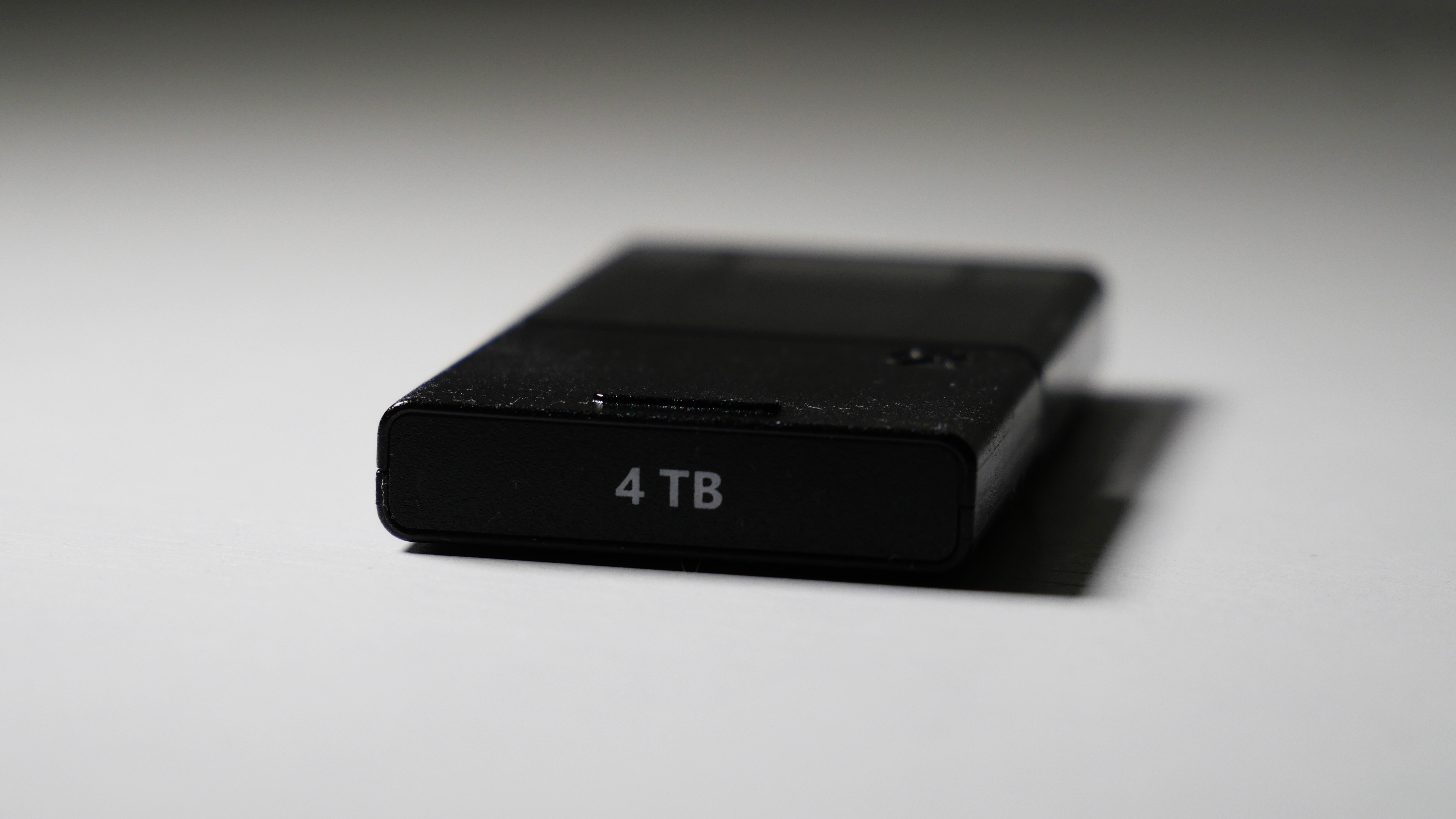 4TB Seagate Storage Expansion Card on a white desk, highlighting its light-and-thin design.
