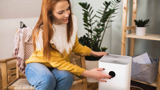 woman using one of the best air purifiers for allergies