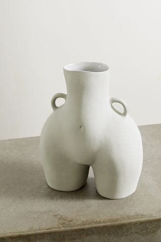 ceramic vase in the shape of a woman's waist hips and thighs with handles at the hips