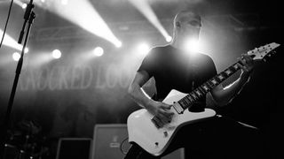 Knocked Loose guitarist Isaac Hale, playing an Ibanez Iceman electric guitar onstage