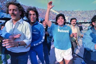 Diego Maradona celebrates on the pitch after Napoli win the Scudetto in May 1987.