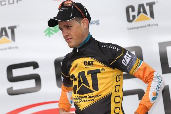 Ben Dyball pulls on the race leaders jersey following his team's win at Tour of Tasmania