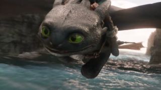 Toothless zooms over the sea in flight in How To Train Your Dragon.