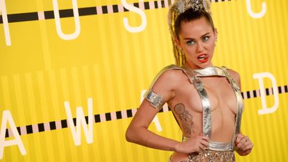 Miley Cyrus' Red Carpet Look from the 2015 MTV VMAs pulling out her tongue
