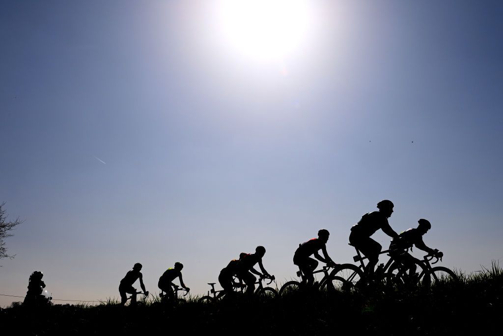 HARELBEKE BELGIUM MARCH 25 Silhouette of Brent Van Moer of Belgium and Team Lotto Soudal Ryan Mullen of Ireland and Team Bora Hansgrohe Jelle Wallays of Belgium and Team Cofidis Lukas Pstlberger of Austria and Team Bora Hansgrohe Daniel Oss of Italy and Team Total Energies Mathijs Paasschens of Netherlands and Team Bingoal Pauwels Sauces WB and Norman Hansen Lasse of Denmark and UNO X Pro Cycling Team competing in the breakaway during the 65th E3 Saxo Bank Classic 2022 a 2039km one day race from Harelbeke to Harelbeke E3SaxobankClassic WorldTour on March 25 2022 in Harelbeke Belgium Photo by Tim de WaeleGetty Images