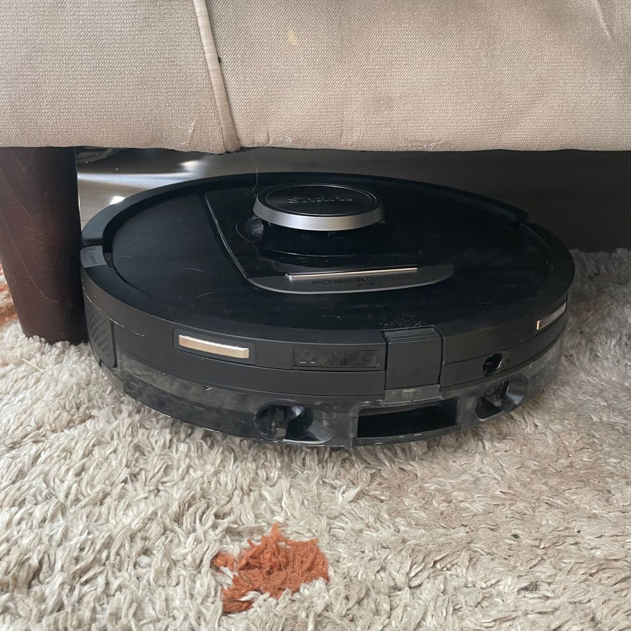 Shark PowerDetect NeverTouch Robot Vacuum going underneath beige sofa