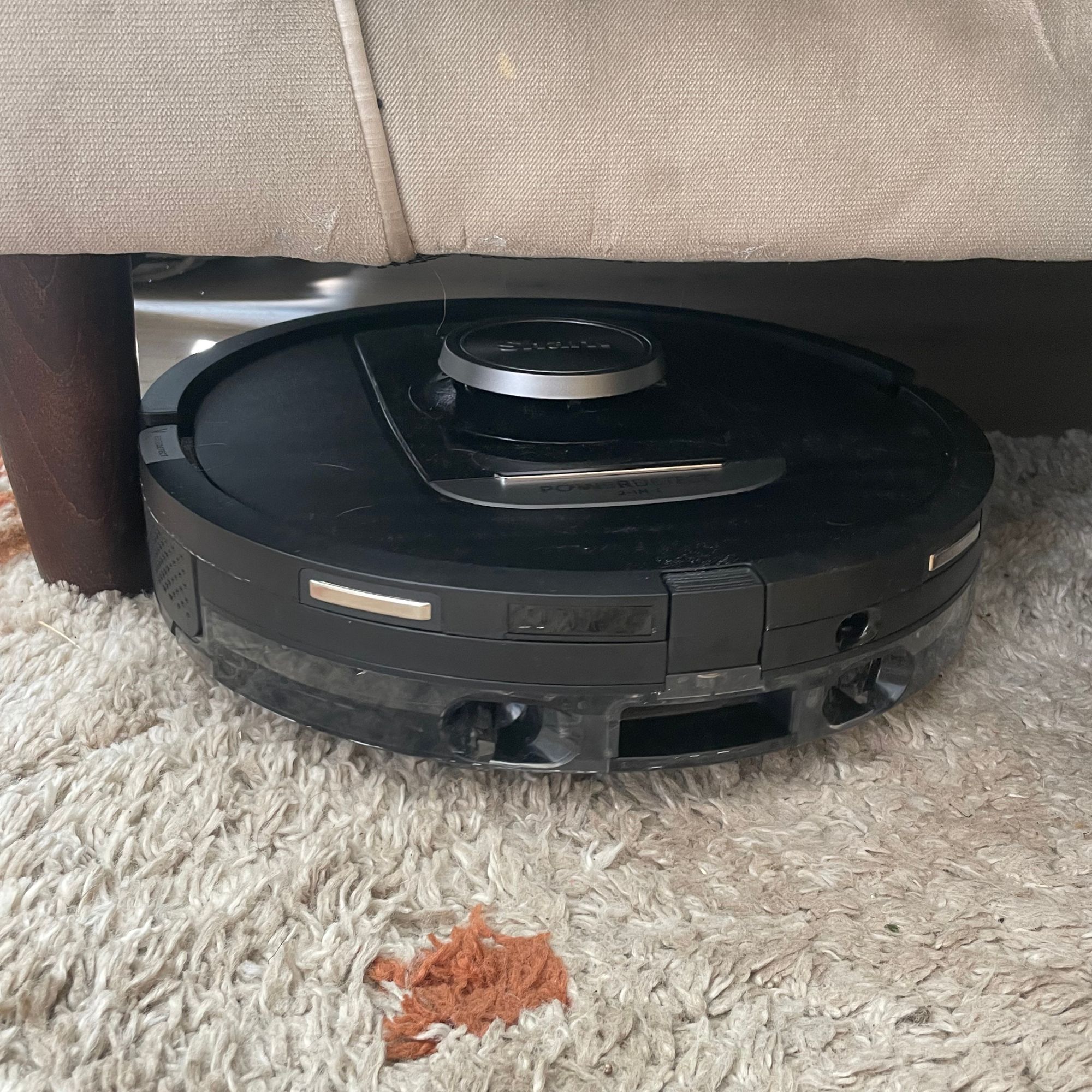 Shark PowerDetect NeverTouch Robot Vacuum going underneath beige sofa