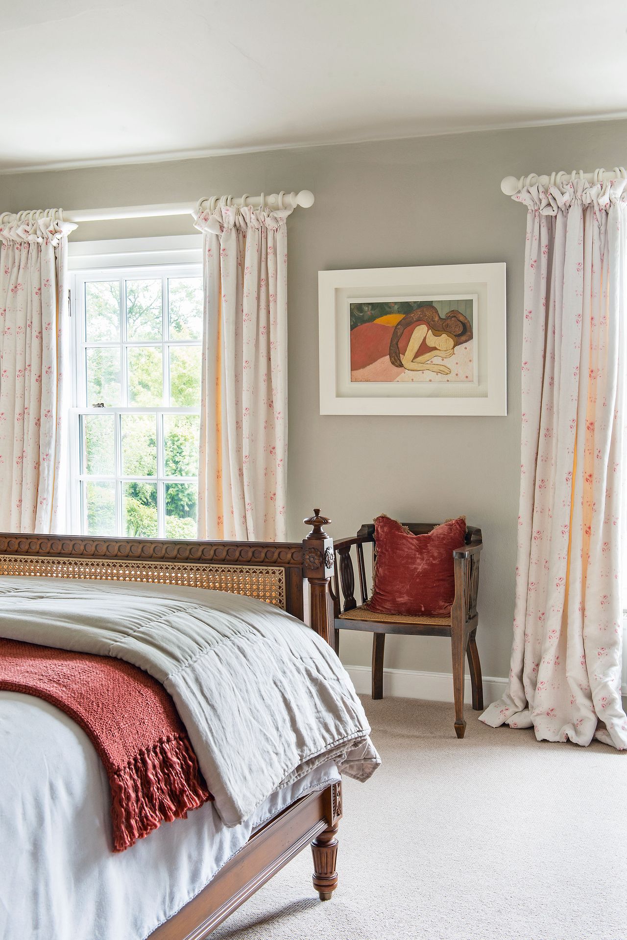 bedroom with georgian window floral linen curtains and antique cane chair