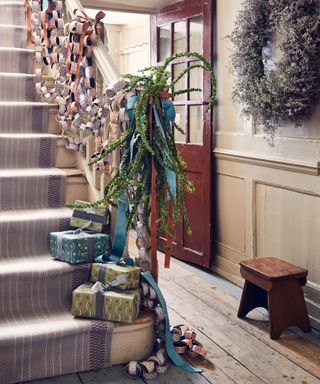 Christmas hallway with gifts on stairs and garland