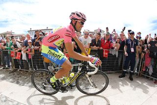 Alberto Contador riding around at sign on