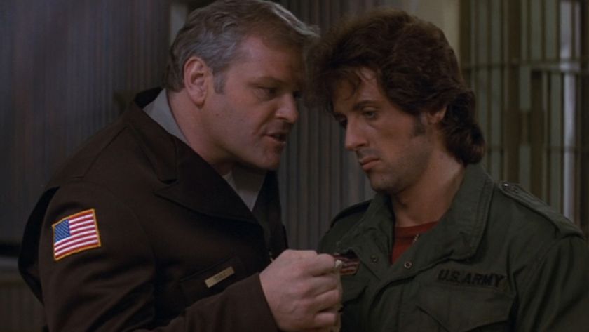 Brian Dennehy speaking sternly to Sylvester Stallone in First Blood